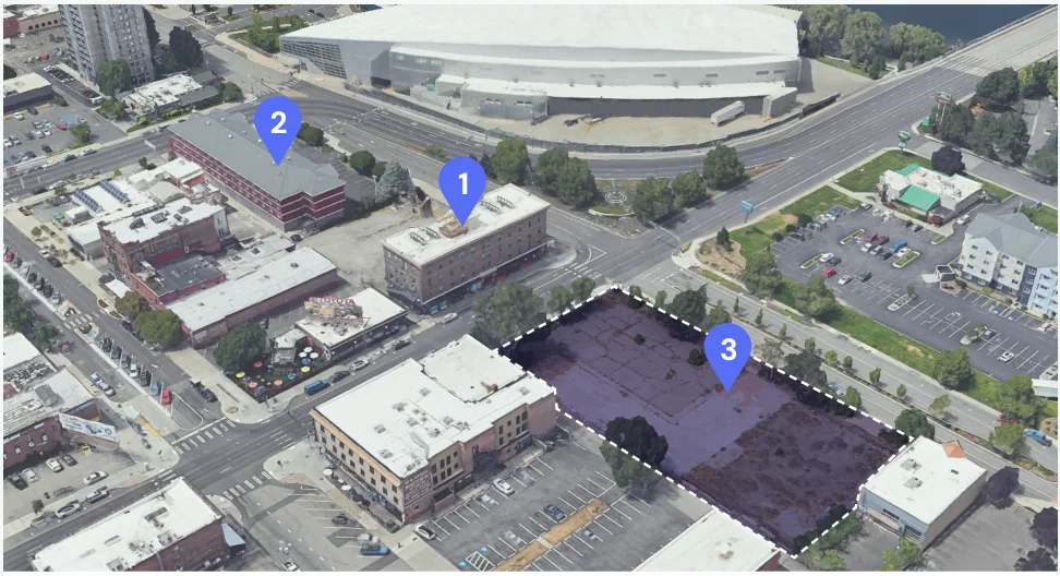 Aerial view near Spokane's convention center tagging a multifamily condo, a hotel, and an adjacent vacant lot.