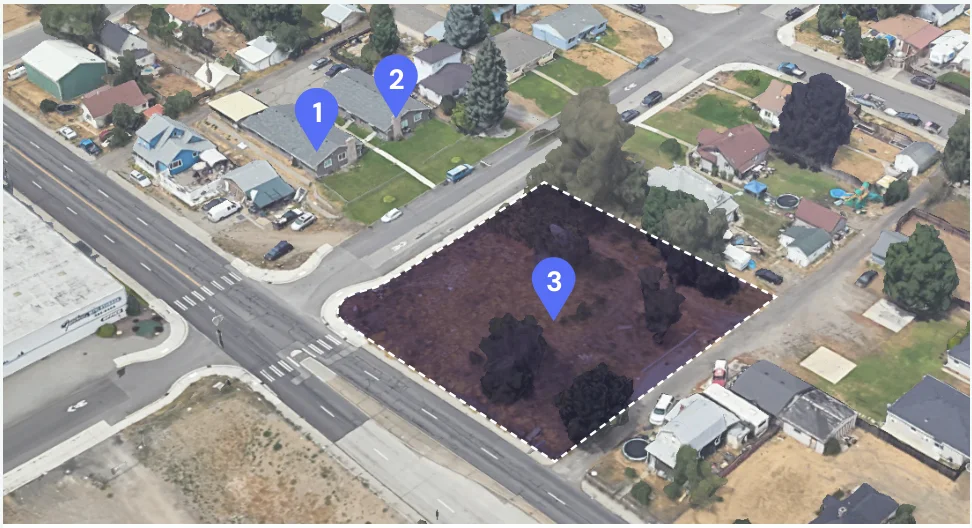 Aerial view of a Spokane residential block tagging two three-unit houses and a neighboring vacant residential lot.