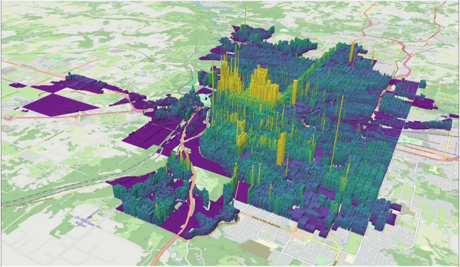 A 3D map of Spokane where each parcel is extruded to a height proportional to its land value per unit of land area. Tall yellow spikes concentrate downtown, tapering to lower blue and purple parcels toward the edges of the city.